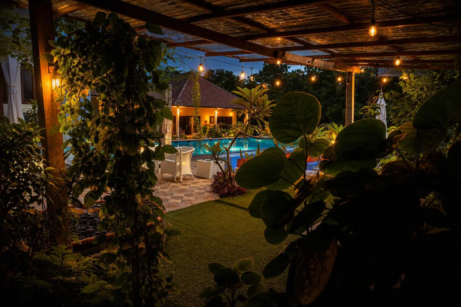 Lit terrace and pool at dusk