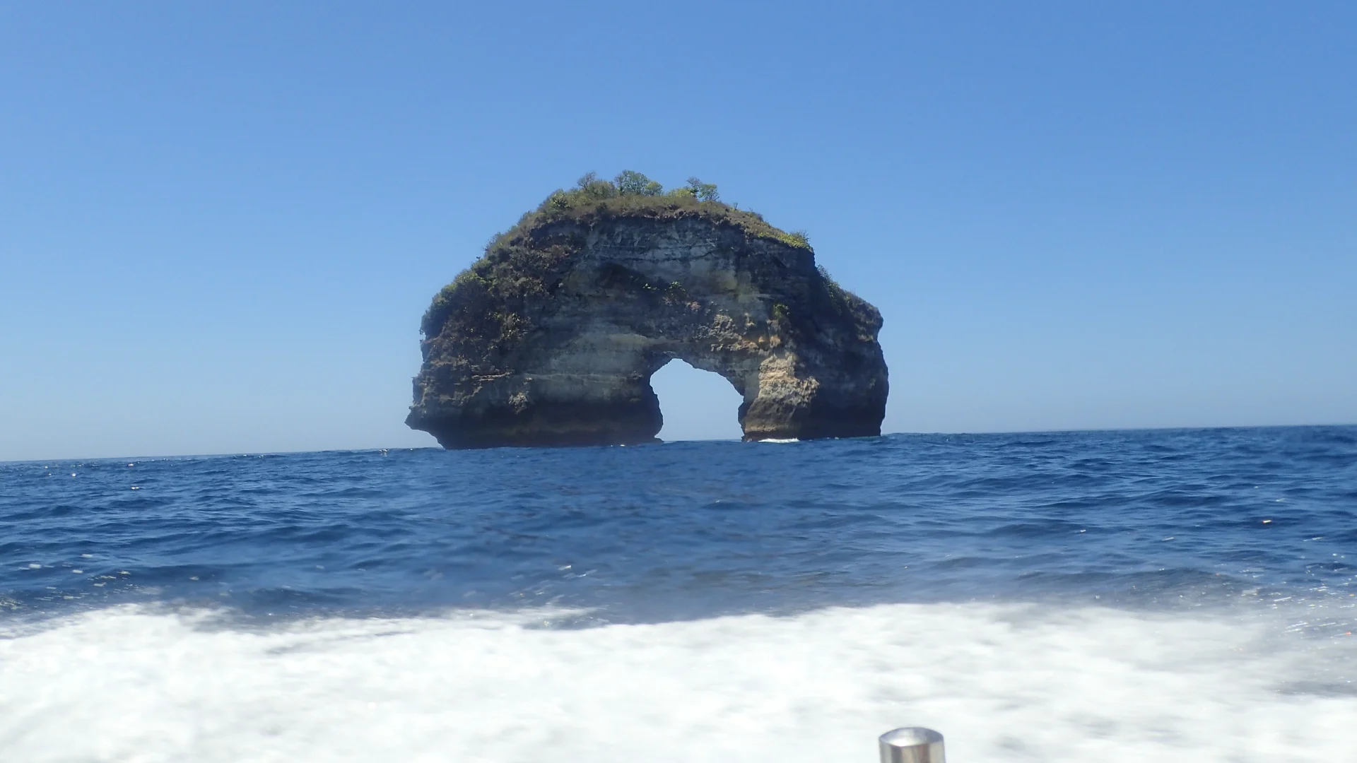 Natural rock arch off Bali’s coast