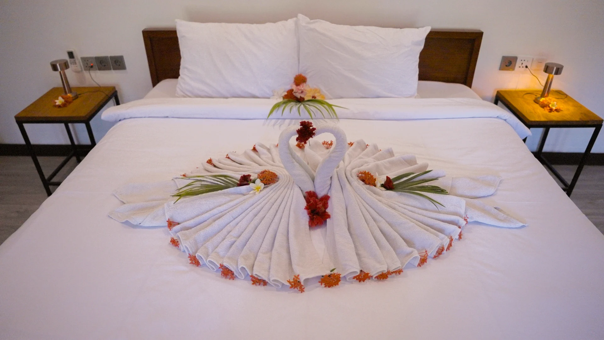 Decorated double bed in the Poolview Deluxe room
