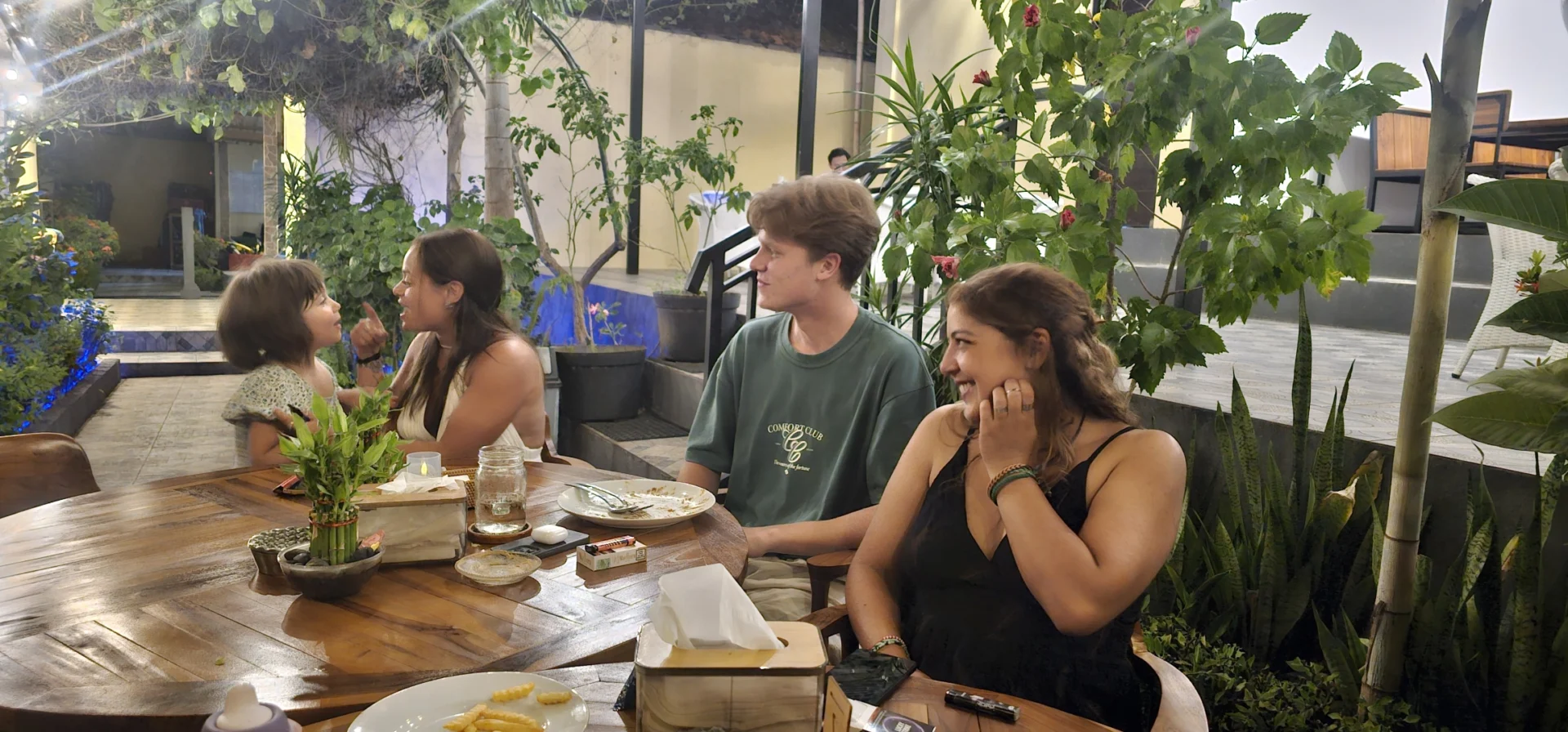 Guests sharing time around a table at The Tribe
