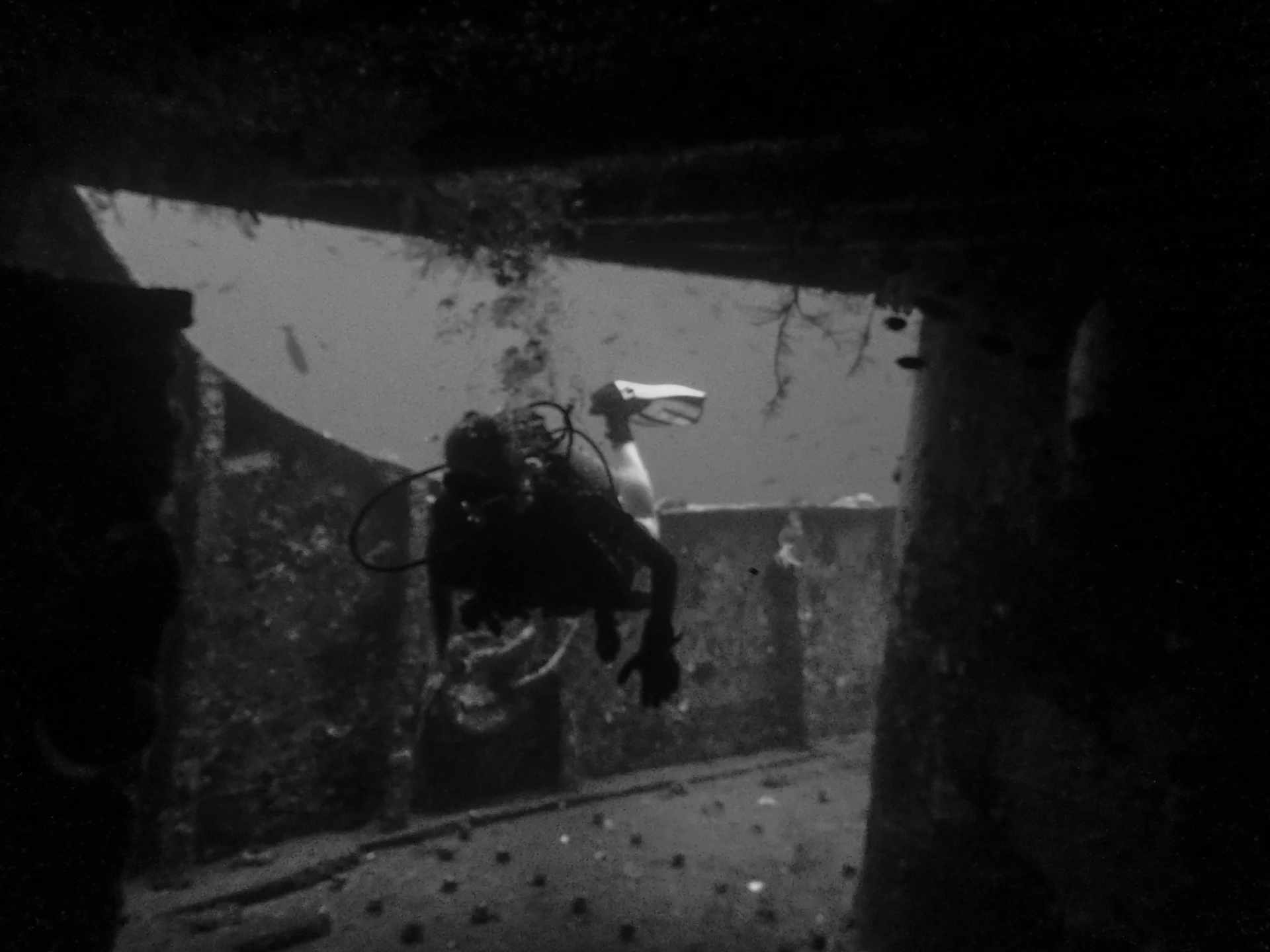 Diver through an opening in Kubu, Bali