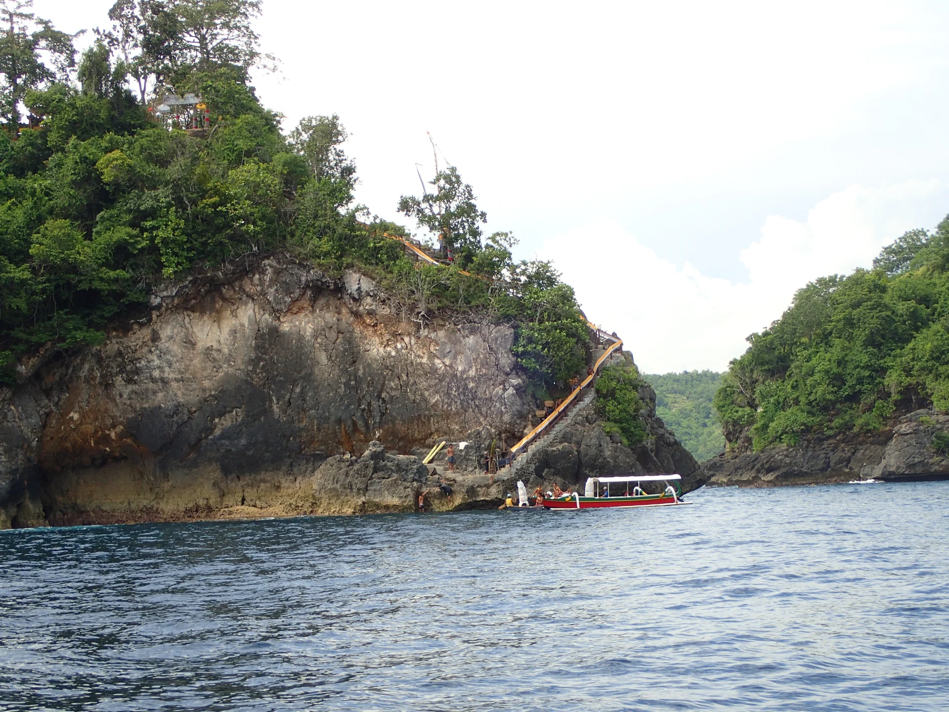 Rocky coast and boat viewed from the sea